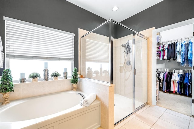 8814 N River Rd, Tampa, FL 33635 - bathroom featuring a garden tub, a stall shower, tile patterned floors, and a spacious closet