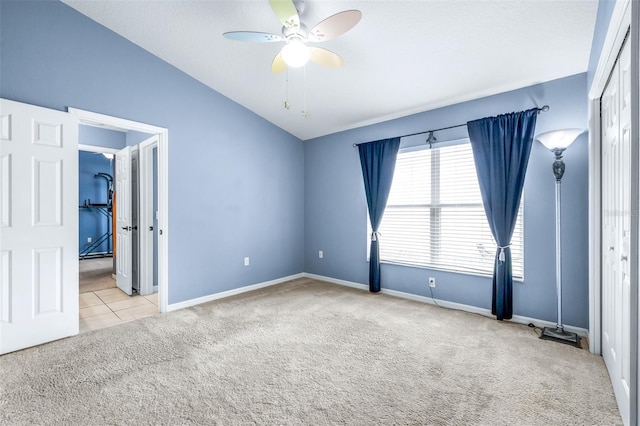 8814 N River Rd, Tampa, FL 33635 - empty room with carpet flooring, vaulted ceiling, ceiling fan, and baseboards