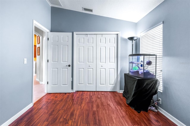 8814 N River Rd, Tampa, FL 33635 - bedroom with vaulted ceiling, dark wood-style flooring, baseboards, and a closet