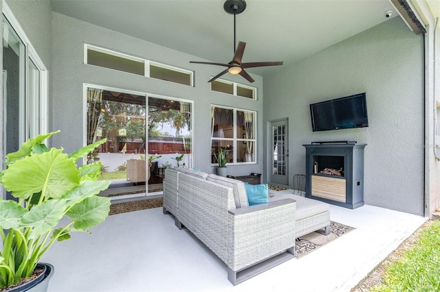8814 N River Rd, Tampa, FL 33635 - living room with ceiling fan, a textured wall, exterior fireplace, and lofted ceiling