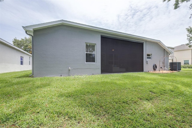8814 N River Rd, Tampa, FL 33635 - back of house with central AC, stucco siding, and a yard