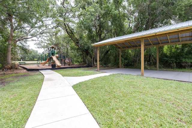 8814 N River Rd, Tampa, FL 33635 - view of home's community featuring a lawn, a carport, and view of wooded area