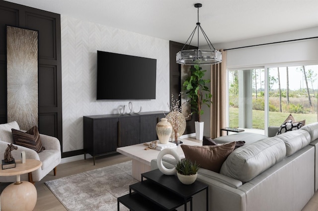 12782 Canter Call Rd, Lithia, FL 33547 - living area with wallpapered walls, an accent wall, a chandelier, baseboards, and light wood-type flooring