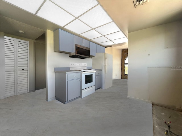 650 Island Way Unit 408, Clearwater Beach, FL 33767 - kitchen with white appliances and gray cabinetry