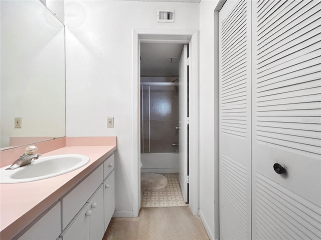 650 Island Way Unit 408, Clearwater Beach, FL 33767 - full bathroom featuring vanity, a closet, shower / bath combination with glass door, and tile patterned floors