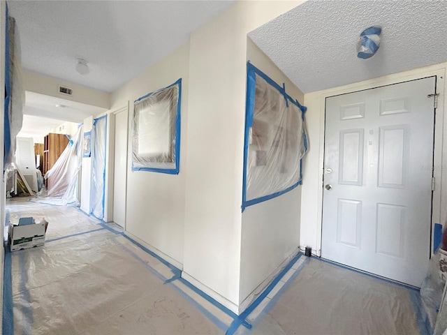 650 Island Way Unit 408, Clearwater Beach, FL 33767 - hallway with a textured ceiling
