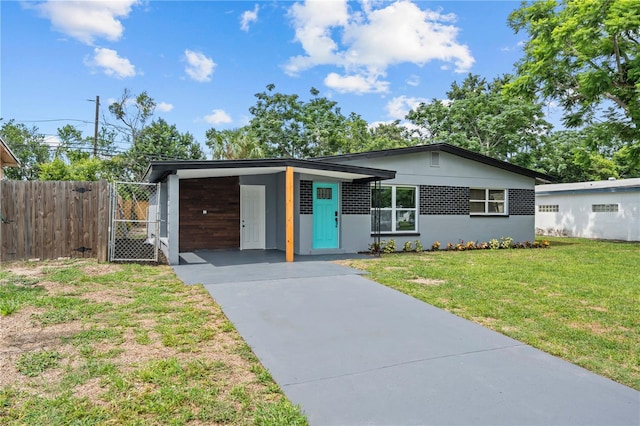 4841 Drift Tide Dr, New Port Richey, FL 34652 - view of front of home with driveway, an attached carport, and a gate