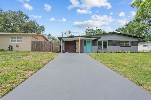 4841 Drift Tide Dr, New Port Richey, FL 34652 - view of front of property featuring a gate, concrete driveway, and a carport