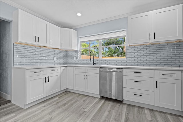 4841 Drift Tide Dr, New Port Richey, FL 34652 - kitchen with dishwasher, light countertops, light wood-type flooring, crown molding, and white cabinetry