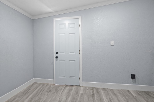 4841 Drift Tide Dr, New Port Richey, FL 34652 - spare room featuring light wood-type flooring and ornamental molding