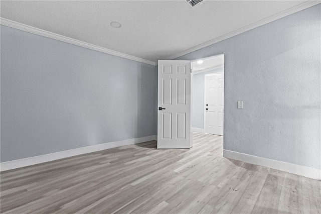 4841 Drift Tide Dr, New Port Richey, FL 34652 - spare room featuring crown molding, light wood-style floors, and a textured wall