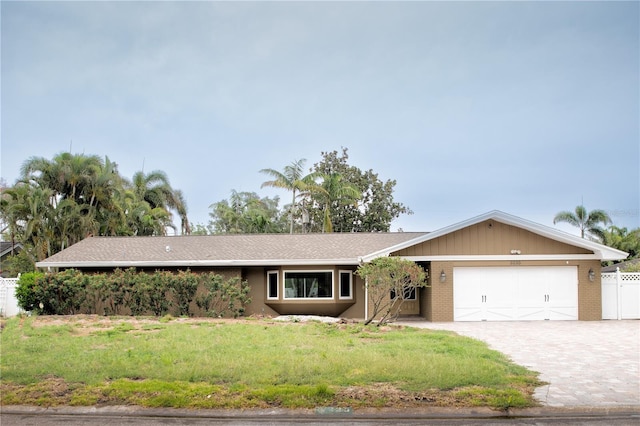 3235 Walnut St NE, Saint Petersburg, FL 33704 - single story home with an attached garage, decorative driveway, and brick siding