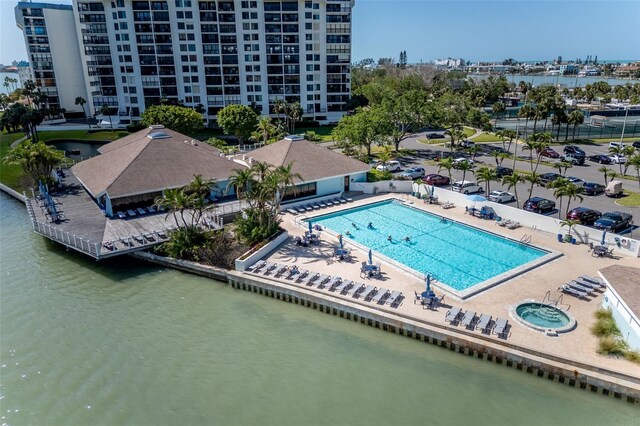 9525 Blind Pass Rd Unit 505, St Pete Beach, FL 33706 - bird's eye view of a nearby body of water, a pool area, and apartment complex