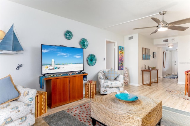 9525 Blind Pass Rd Unit 505, St Pete Beach, FL 33706 - living area with wood finished floors, a ceiling fan, and baseboards