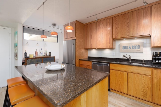 9525 Blind Pass Rd Unit 505, St Pete Beach, FL 33706 - kitchen featuring appliances with stainless steel finishes, a sink, dark stone countertops, and backsplash