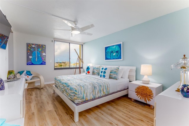 9525 Blind Pass Rd Unit 505, St Pete Beach, FL 33706 - bedroom with light wood finished floors, baseboards, and ceiling fan