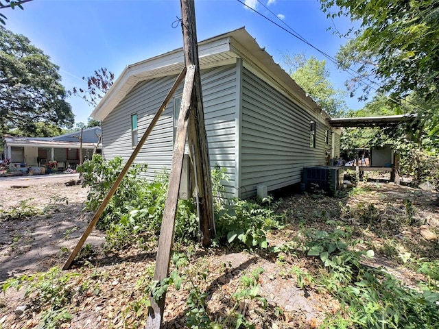 14210 Downing St, Dover, FL 33527 - view of home's exterior featuring central AC