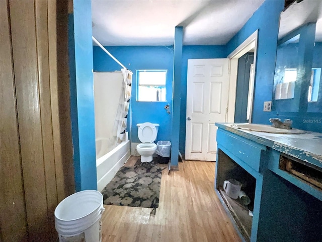 14210 Downing St, Dover, FL 33527 - full bathroom featuring toilet, shower / bathtub combination with curtain, vanity, and wood finished floors
