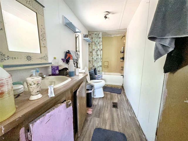 14210 Downing St, Dover, FL 33527 - full bath with toilet, wood finished floors, vanity, and shower / bath combo with shower curtain