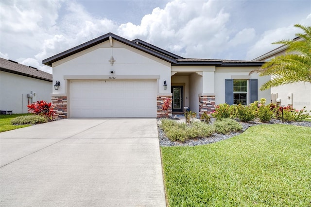 30762 Parrot Reef Ct, Wesley Chapel, FL 33545 - view of front facade featuring stone siding, stucco siding, driveway, an attached garage, and a front yard