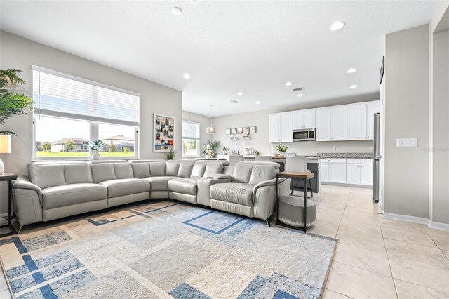 30762 Parrot Reef Ct, Wesley Chapel, FL 33545 - living area featuring light tile patterned flooring, recessed lighting, and baseboards