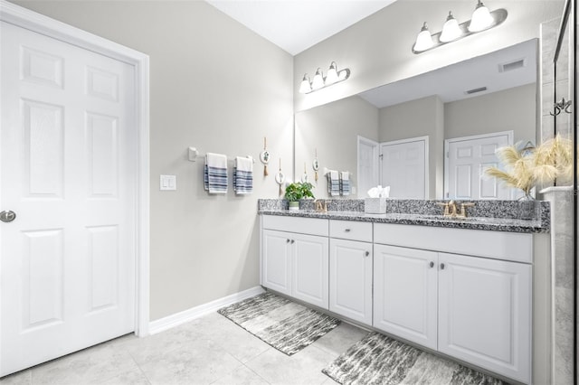 30762 Parrot Reef Ct, Wesley Chapel, FL 33545 - bathroom with double vanity, baseboards, and tile patterned flooring