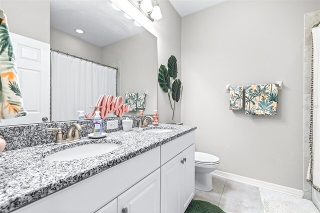 30762 Parrot Reef Ct, Wesley Chapel, FL 33545 - bathroom with toilet, double vanity, tile patterned flooring, baseboards, and a shower with shower curtain