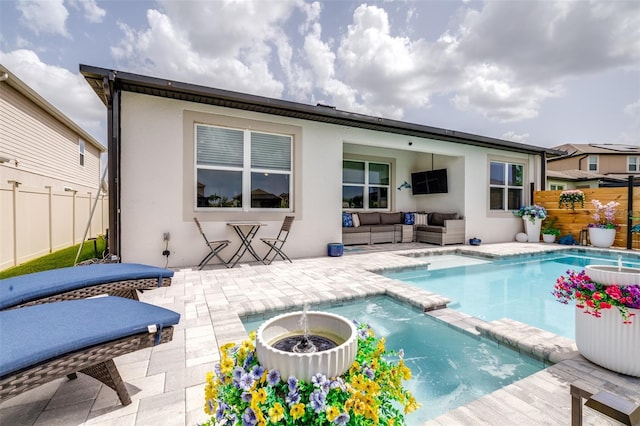 30762 Parrot Reef Ct, Wesley Chapel, FL 33545 - back of property featuring a pool with connected hot tub, an outdoor living space, a patio area, and stucco siding