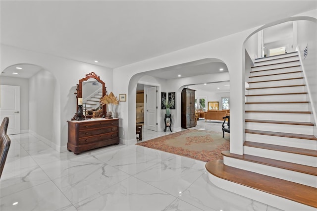 208 Live Oak Ln, Largo, FL 33770 - foyer entrance featuring stairway, marble tiled flooring, arched walkways, and recessed lighting