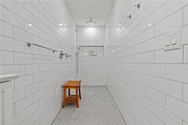 208 Live Oak Ln, Largo, FL 33770 - bathroom featuring tiled shower, tile walls, and tile patterned floors