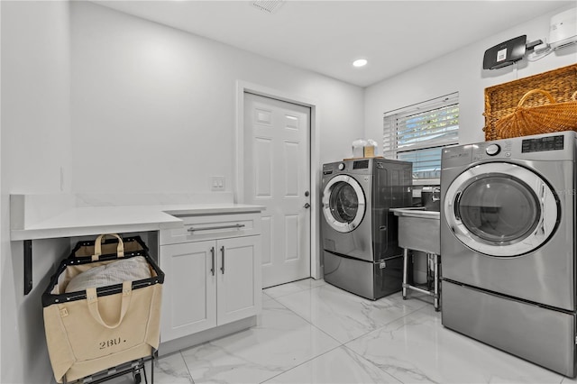208 Live Oak Ln, Largo, FL 33770 - laundry room with washer and clothes dryer, cabinet space, light marble finish flooring, and recessed lighting