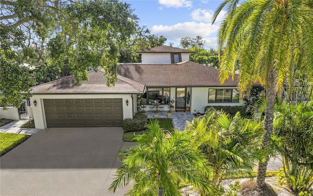 208 Live Oak Ln, Largo, FL 33770 - view of front of property with stucco siding, concrete driveway, and an attached garage