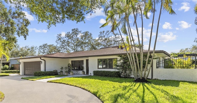208 Live Oak Ln, Largo, FL 33770 - view of front of property with stucco siding, an attached garage, and driveway
