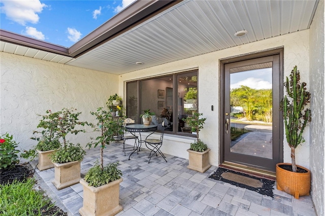 208 Live Oak Ln, Largo, FL 33770 - view of exterior entry with stucco siding and a patio area