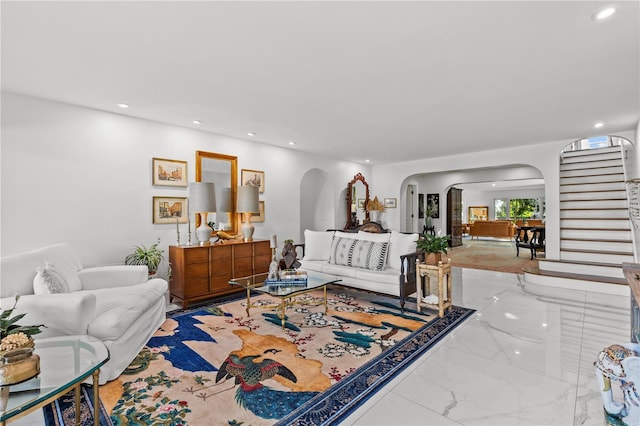 208 Live Oak Ln, Largo, FL 33770 - living area featuring arched walkways, marble tiled flooring, stairway, and recessed lighting