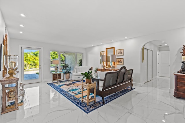 208 Live Oak Ln, Largo, FL 33770 - living room with arched walkways, light marble finish floors, and recessed lighting