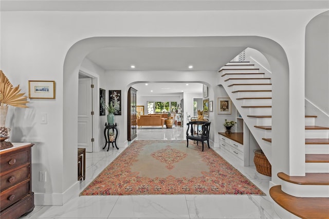 208 Live Oak Ln, Largo, FL 33770 - entrance foyer featuring arched walkways, light marble finish flooring, stairway, and recessed lighting
