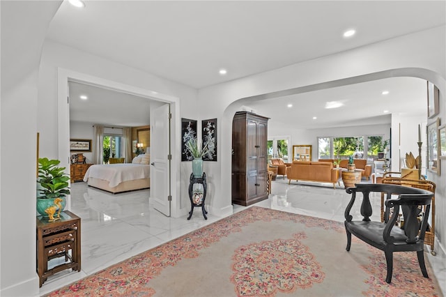 208 Live Oak Ln, Largo, FL 33770 - foyer with light marble finish flooring, arched walkways, and recessed lighting