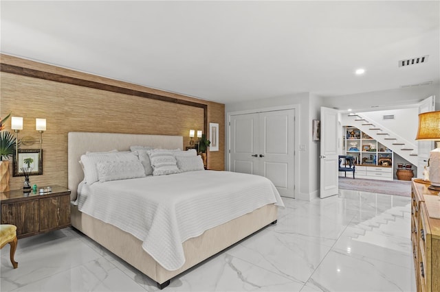 208 Live Oak Ln, Largo, FL 33770 - bedroom featuring light marble finish flooring, recessed lighting, a closet, an accent wall, and wood walls