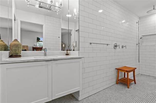 208 Live Oak Ln, Largo, FL 33770 - full bath featuring tile patterned flooring, a tile shower, tile walls, and vanity
