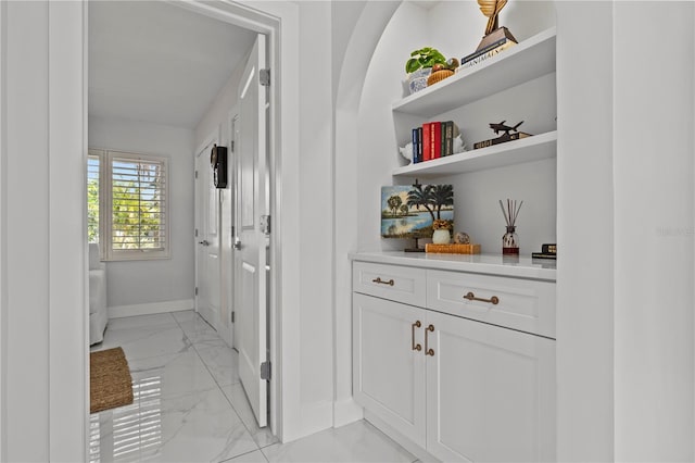 208 Live Oak Ln, Largo, FL 33770 - hall featuring light marble finish flooring and baseboards