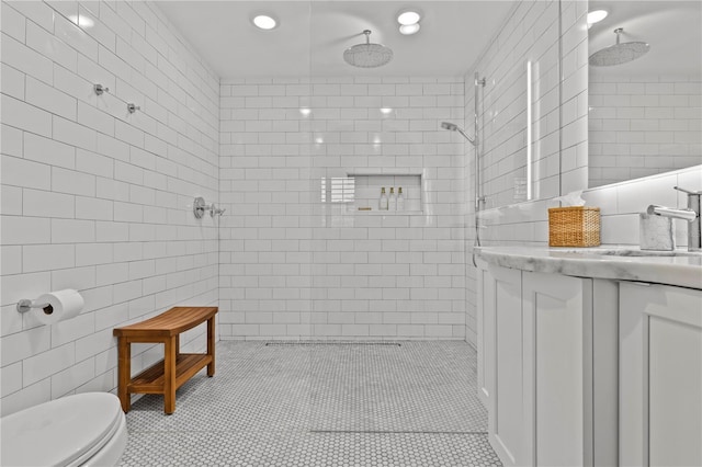 208 Live Oak Ln, Largo, FL 33770 - bathroom featuring tile walls, vanity, a tile shower, tile patterned floors, and recessed lighting