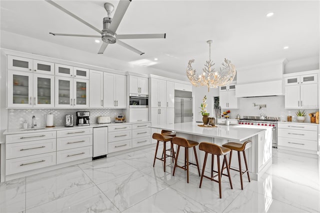 208 Live Oak Ln, Largo, FL 33770 - kitchen featuring premium appliances, decorative backsplash, recessed lighting, light countertops, and light marble finish floors