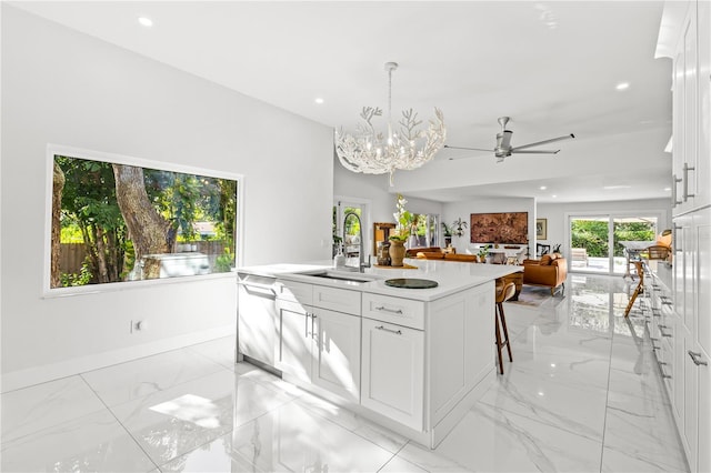 208 Live Oak Ln, Largo, FL 33770 - kitchen featuring dishwasher, light marble finish flooring, white cabinets, a kitchen island with sink, and a ceiling fan