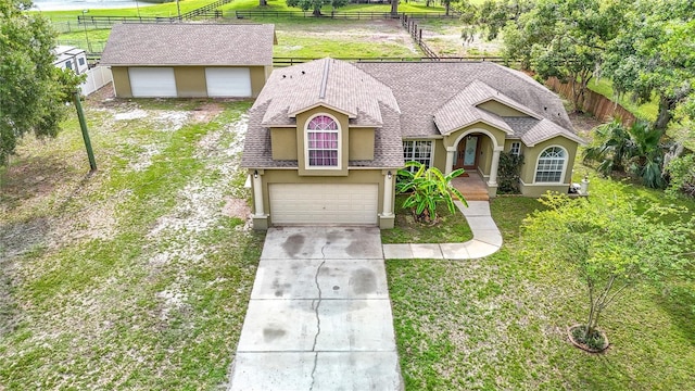 1332 Osceola Hollow Rd, Odessa, FL 33556 - view of front facade with stucco siding, concrete driveway, an attached garage, and roof with shingles