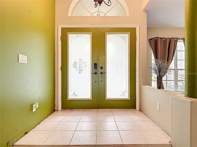 1332 Osceola Hollow Rd, Odessa, FL 33556 - entryway with healthy amount of natural light, french doors, a textured wall, and light tile patterned flooring