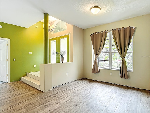 1332 Osceola Hollow Rd, Odessa, FL 33556 - foyer entrance with wood finished floors, a chandelier, and a textured ceiling