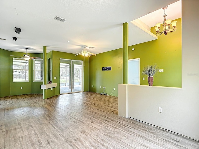 1332 Osceola Hollow Rd, Odessa, FL 33556 - unfurnished living room featuring a ceiling fan, healthy amount of natural light, and light wood-style floors