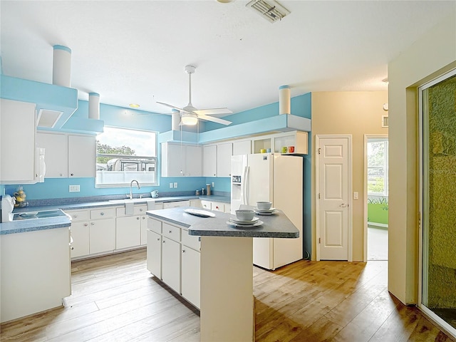 1332 Osceola Hollow Rd, Odessa, FL 33556 - kitchen with white appliances, a ceiling fan, healthy amount of natural light, and light wood finished floors