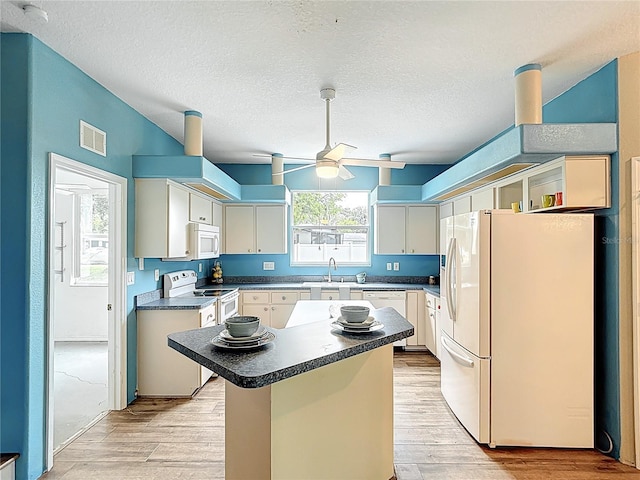 1332 Osceola Hollow Rd, Odessa, FL 33556 - kitchen with white appliances, ceiling fan, a sink, light wood-style flooring, and a textured ceiling